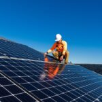 man on roof installing solar panels